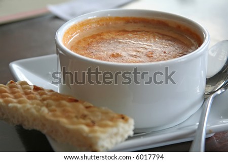 Bowl of lobster bisque in white bowl casual restaurant setting