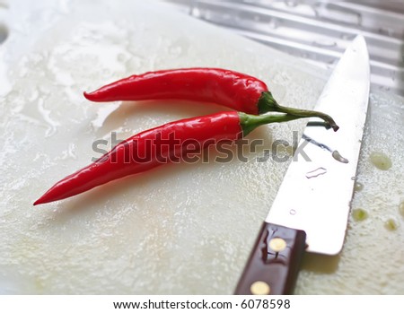 Fresh chillis on the chopping board cooking preparation in the kitchen