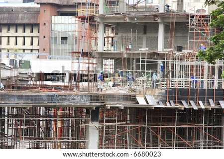 Urban construction site with workmen in downtown manila