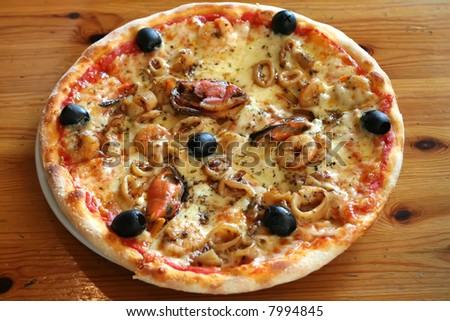 Traditional italian seafood pizza with prawns and mussels