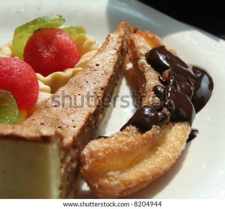 Dessert fruit cups and pastries on white plate