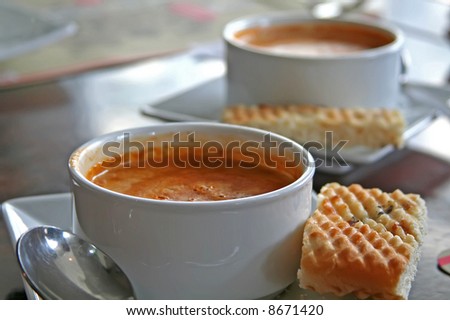 Bowl of lobster bisque in white bowl casual restaurant setting