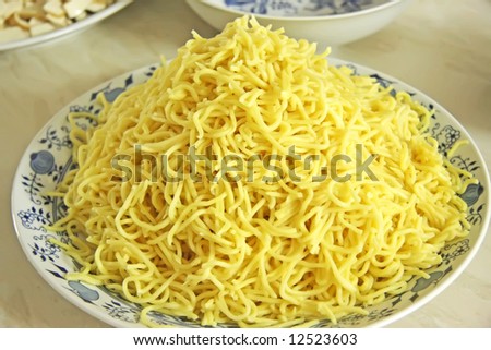 Pile of cooked egg noodles traditional asian pasta