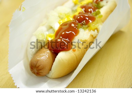 Hotdog fastfood sausage in bun with condiments