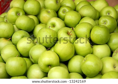 Pile of many fresh green apples in the market