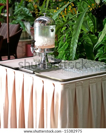 Drink dispenser and glasses in a hotel with ice