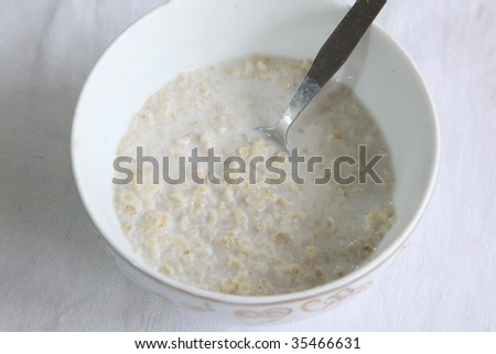 Bowl of rolled oats soaked in milk, breakfast cereal