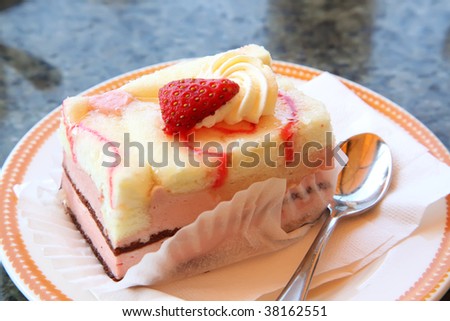 Layered strawberry chiffon cake dessert decorated with fruit