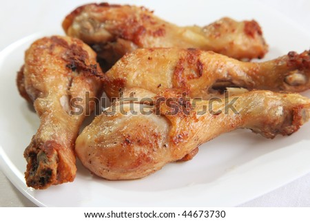 Fried chicken drumstick meat parts on white plate
