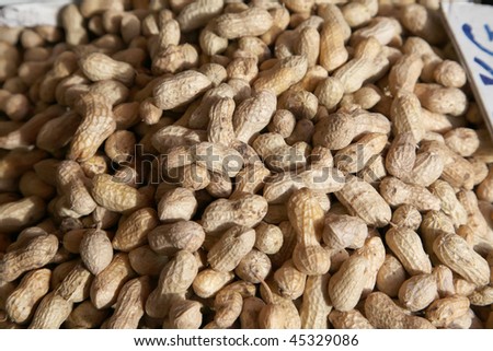 Many fresh whole raw peanuts in shell, background texture