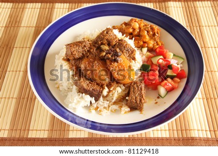Asian Indian style beef curry on rice with two side dishes
