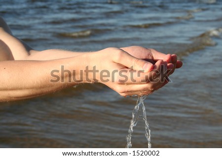 Strong man hands with flowing water