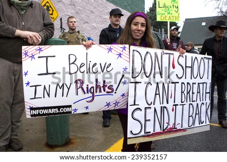 Spokane, Washington USA - December 20, 2014. A woman holds a protest sign at a rally in Spokane Valley, Washington.