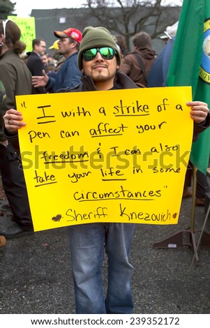 Spokane, Washington USA - December 20, 2014. A man attending a protest in Spokane, Valley, Washington holds up a sign.