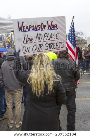 Spokane, Washington USA - December 20, 2014. A woman holds a protest sign at a rally in Spokane Valley, Washington.