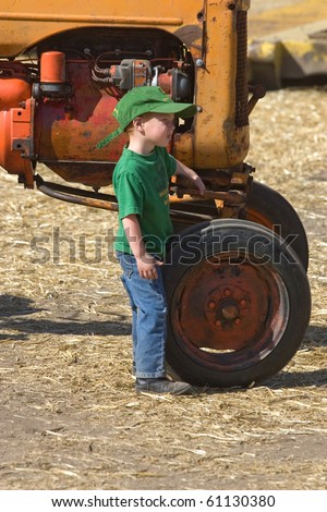 COLFAX, WASHINGTON-SEPT 6:A young future farmer stand by a tractor during the Sept 6, 2010 threshing bee in Colfax, Washington.