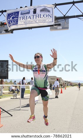 RATHDUM, IDAHO - JUNE 5: An unidentified runner jumps across the finish line after completing the Radiant Lake Mini Triathlon on June 5, 2011 in Rathdum, Idaho.