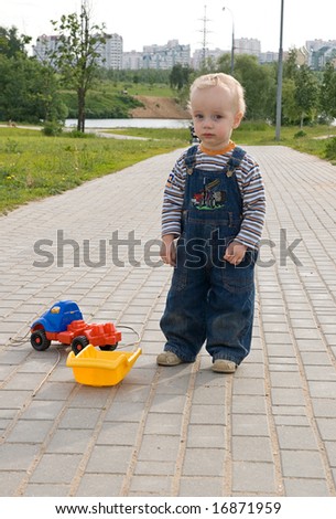 Sad boy with a broken toy truck