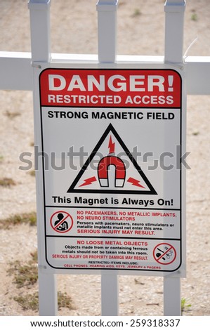 A sign reading Danger Restricted Access Strong Magnetic Field