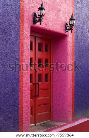 Colorful wall with red door and black iron lights