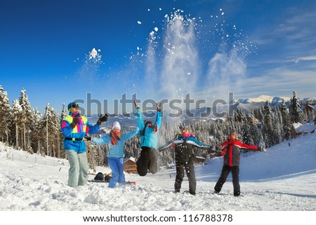 Young people throwing up snow in winter background