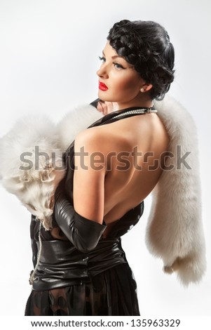 Retro portrait of sexy caucasian young woman model with with white fox fur collar