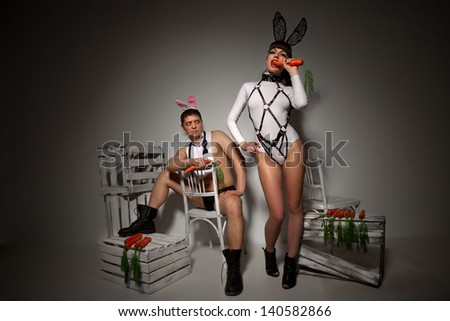 Lovely couple in rabbit costumes with carrots