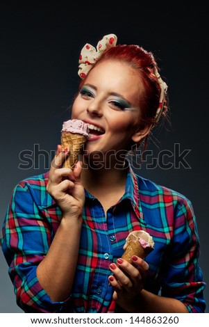 Bright picture of pretty girl in checked shirt with ice-cream in studio.