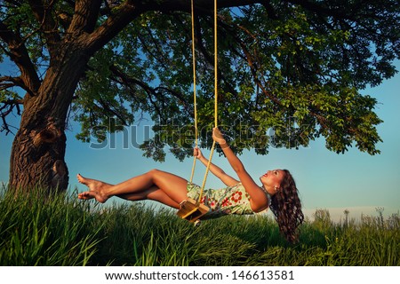 Beautiful Girl On The Swing In The Forest