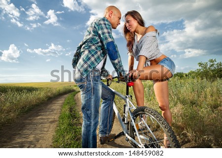bike couple walking on field
