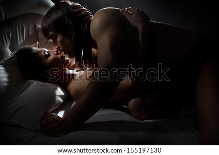 Young man and woman kissing in darkness