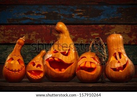 Scary Jack O Lantern Halloween pumpkins in darkness
