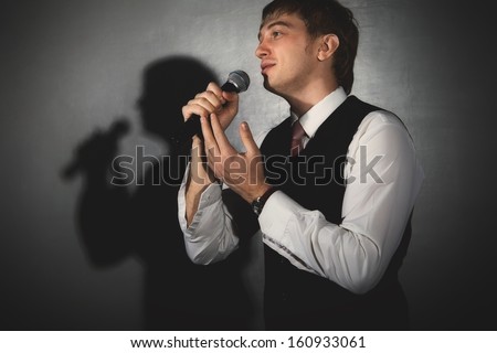 Young handsome guy singing. Jazz musician