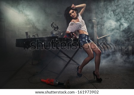 Girl at a garage next to the Go-kart  in smoke