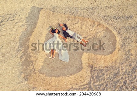 Beach wedding of happy newlywed couple