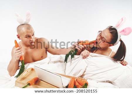 Lovely couple in rabbit costumes in bed