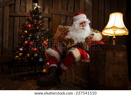 Santa Claus sitting at home near Christmas tree and  resting