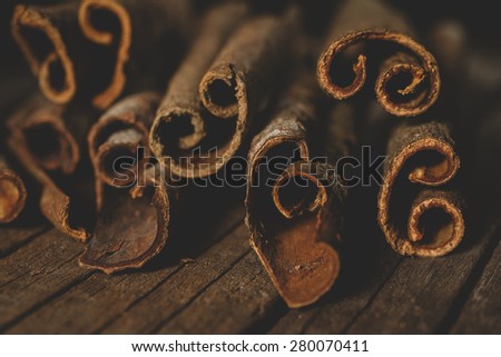 Close up of cinnamon sticks on wooden background