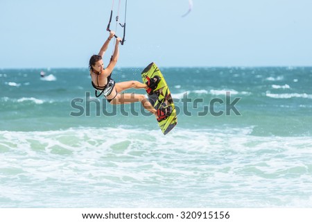 A kite surfer rides the waves.