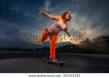 Funny overweight woman skateboarding.