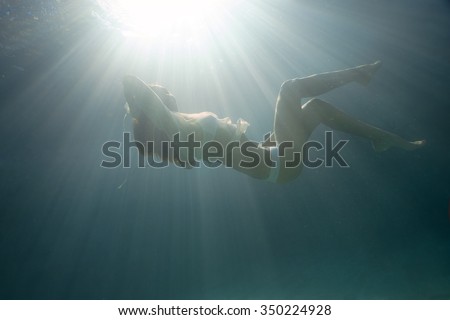 Underwater shoot of a relaxed  flying  woman