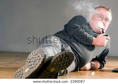 Old man smoking wooden pipe