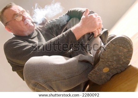 Old man smoking wooden pipe