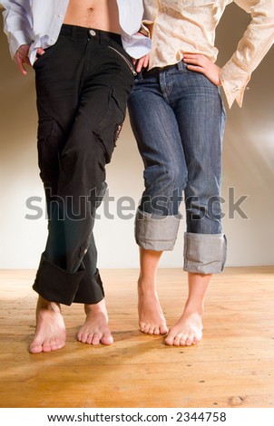 stock photo Pair of young people wear jeans standing with bare feet