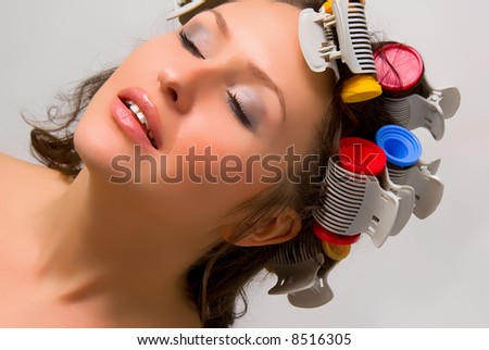 Nice girl with colorful hair-curlers