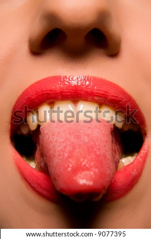 Beautiful woman face with tongue out close-up
