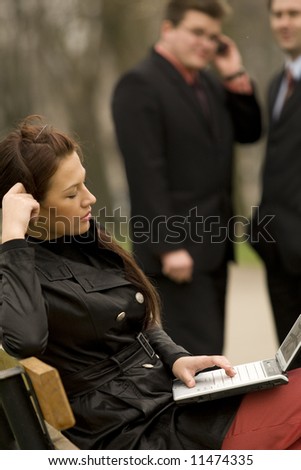 Business team with laptop at outdoor meeting