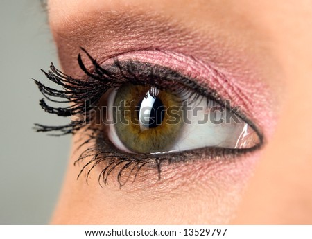 beautiful woman`s open green eye close-up