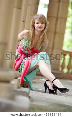 Beautiful blond woman on roman style columns background