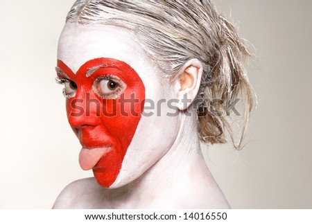 Young beautiful model with red heart shape painted on face